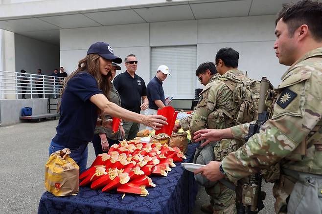 크리스티 노엠 미국 국토안보부 장관이 12일 미국 캘리포니아주 로스앤젤레스 FBI 건물에서 주방위군에게 맥도날드 감자튀김을 제공하고 있다. /연합뉴스