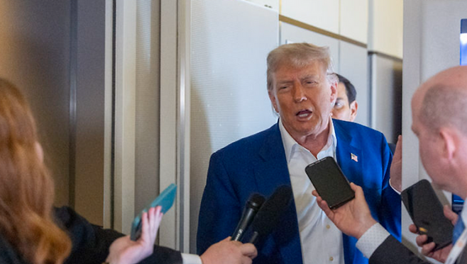 도널드 트럼프 미국 대통령이 24일(현지시간) 대통령 전용기(에어포스원)에서 기자들의 질문을 받고 있다. ⓒAP/뉴시스
