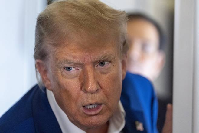 도널드 트럼프 미국 대통령이 24일(현지 시간) 메릴랜드주 프린스 조지 카운티에 있는 조인트 베이스 앤드루스에서 북대서양조약기구(나토) 정상회의 참석 차 네덜란드로 향하는 전용기에 탑승해 취재진 질문을 듣고 있다. 프린스 조지 카운티=AP/뉴시스