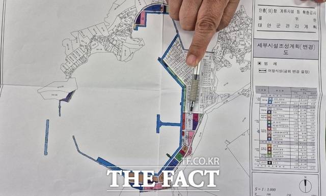 태안군 관계자가 문제의 어항시설 수산물판매처리장 구역을 손으로 가리키고 있다. /이수홍 기자