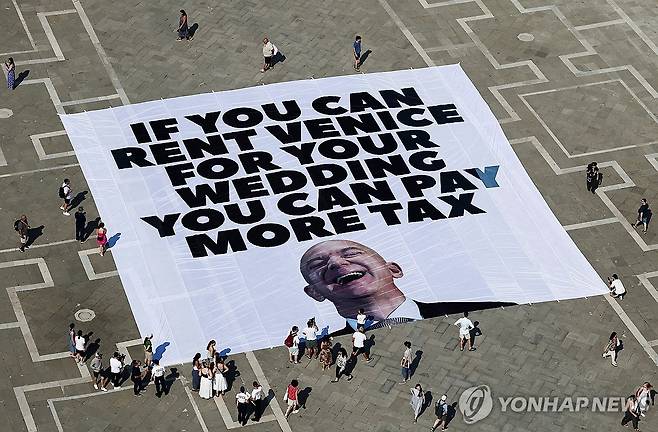 '결혼식을 위해 베네치아를 빌릴 수 있다면 세금을 더 많이 내야 한다'  23일(현지시간) 베네치아 산마르코 광장에 설치된 베이조스 결혼식 반대 현수막. [로이터 연합뉴스 자료사진. 재배포 및 DB 금지]