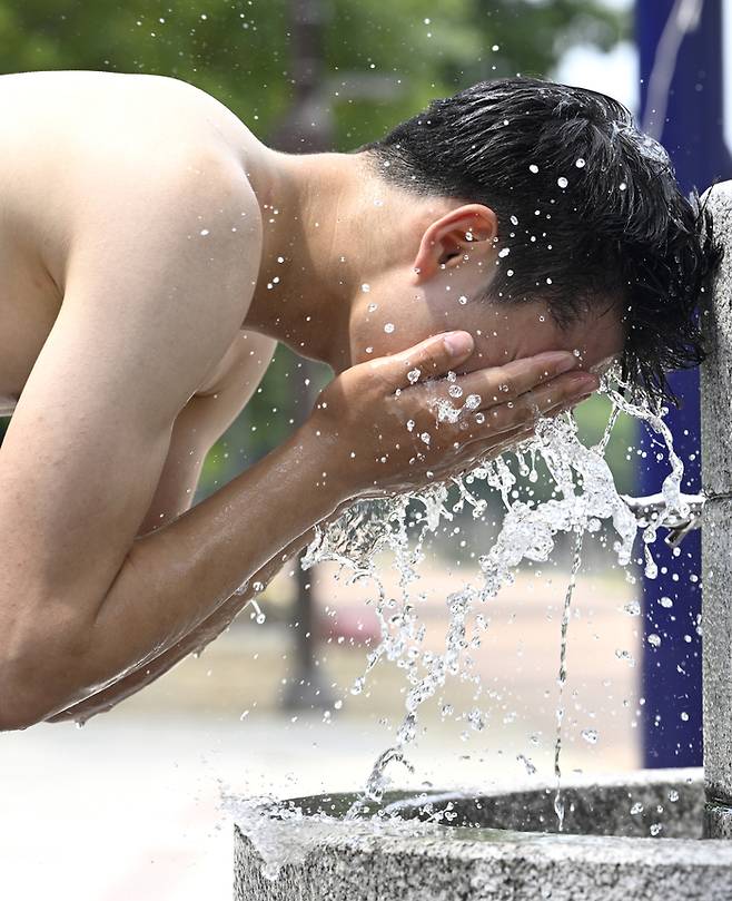 대구 중구 신천둔치 중구체육광장에서 운동을 마친 한 시민이 머리를 감으며 더위를 식히고 있다.이윤호기자 yoonhohi@yeongnam.com