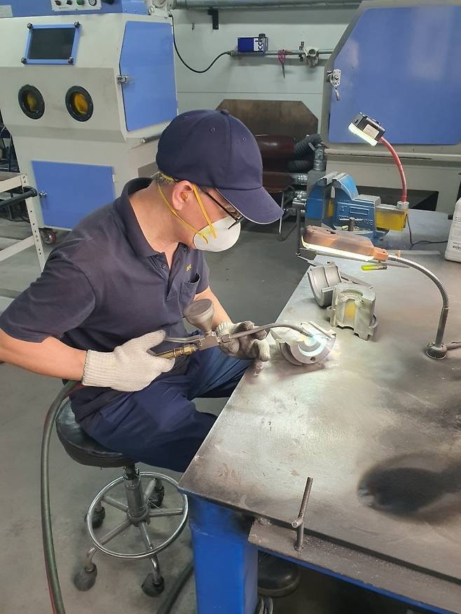 조명희 과장이 금형 파우더 용접을 하고 있다. 안성=윤현주 기자