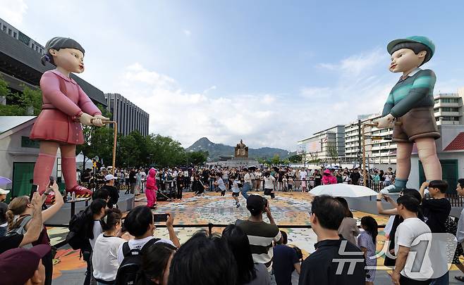 29일 오후 서울 세종대로 광화문광장에서 '2025 K콘텐츠 서울여행주간: 소울스팟을 찾아라' 행사의 일환으로 마련된 넷플릭스 오징어 게임 체험존에서 시민들이 단체 줄넘기를 하고 있다. 2025.6.29/뉴스1 ⓒ News1 이승배 기자