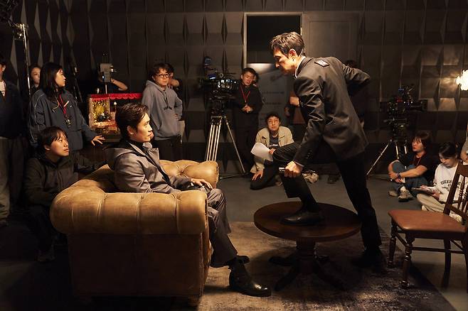 Lee Byung-hun (left), director Hwang Dong-hyuk (center, back) and Lee Jung-jae (right) are seen at the filming set of "Squid Game" Season 3 (Netflix)