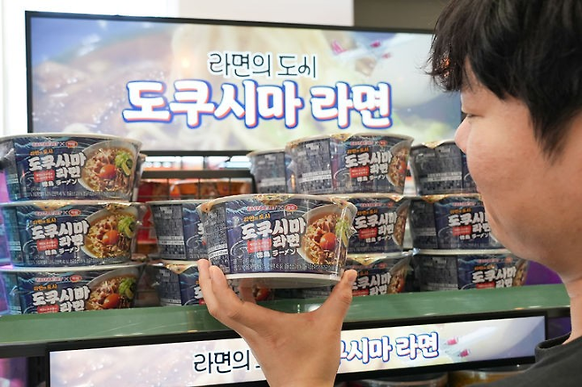 한 고객이 편의점에 진열된 도쿠시마 라면 제품을 들여다보고 있다. [세븐일레븐 제공]