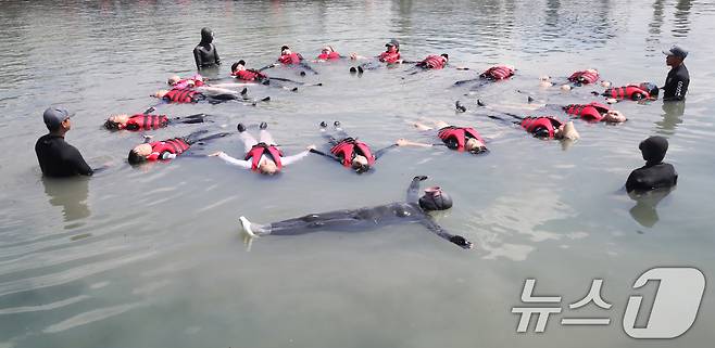 8일 오전 제주 서귀포시 법환어촌계 해녀체험장에서 강정초등학교 학생들이 해녀와 해군 해난구조대(SSU)로부터 '제주형 생존수영' 교육을 받고 있다. 2025.7.8/뉴스1 ⓒ News1 오현지 기자