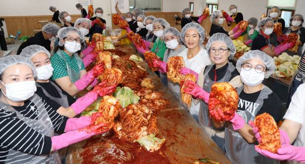 정영희 두성재단 대표이사(오른쪽에서 두번째), 임경자(명현관 해남군수) 부인, 해남땅끝와이즈멘, 해남목련로타리클럽, 김영동 해남종합사회복지관장과 직원 등 50여명이 9일 해남종합사회복지관 1층 다목적강당에서 열린  ‘여름 김장김치 나누기’ 행사에서 김치를 담고 있다. 김양배 기자
