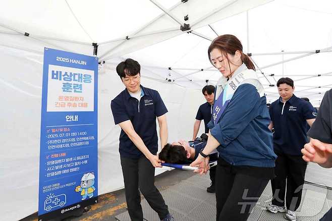 한진 조현민 사장이 온열질환 발생 환자를 들것으로 옮기는 대응훈련을 하고 있다. (한진 제공) ⓒ News1