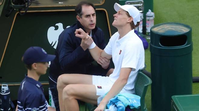 야니크 시너가 지난 7일 그리고르 디미트로프와의 2025 윔블던 남자단식 16강전 초반 엘보 부상을 당한 뒤 메디컬 타임아웃 때 고통스러워 하고 있다. 사진/ATP 투어