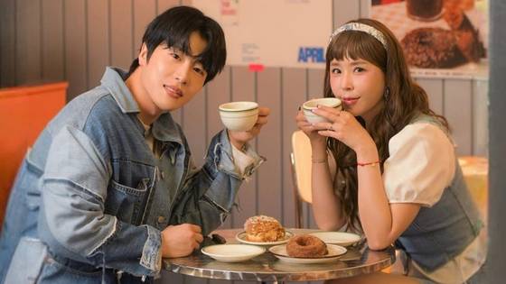 Shinji of veteran K-pop group Koyote, right, and her fiance, singer MoonOne, in a promotional photo for a duet song [SCREEN CAPTURE]