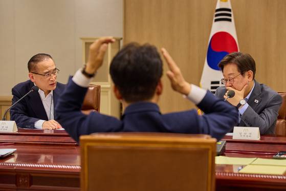 President Lee Jae Myung, right, speaks with National Security Adviser Wi Sung-lac, left, during a National Security Council meeting at the presidential office in Yongsan, central Seoul, on July 10, in this photo uploaded to President Lee's social media. [NEWS1]