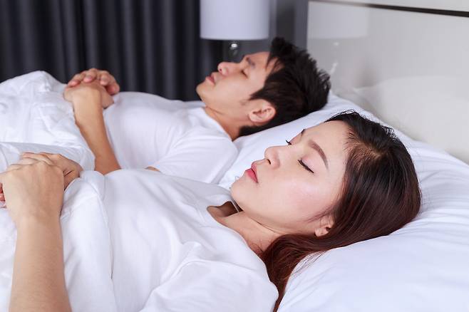 한 침대에서 잠을 자는 부부. 사진은 기사 내용과 무관 [123RF]