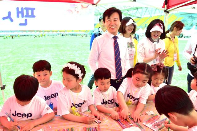 어린이날 체험 프로그램 행사에 참여한 조규일 시장이 어린이들과 기념촬영을 하고 있다.