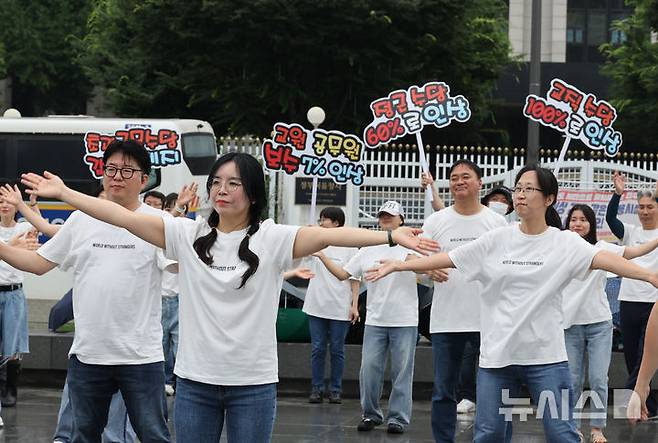 [서울=뉴시스] 김명원 기자 = 한국노총 소속 공무원 교사 60명이 16일 오전 서울 종로구 정부서울청사 앞에서 공무원 보수 현실화 촉구 플래시몹을 진행하고 있다. 2025.07.16. kmx1105@newsis.com
