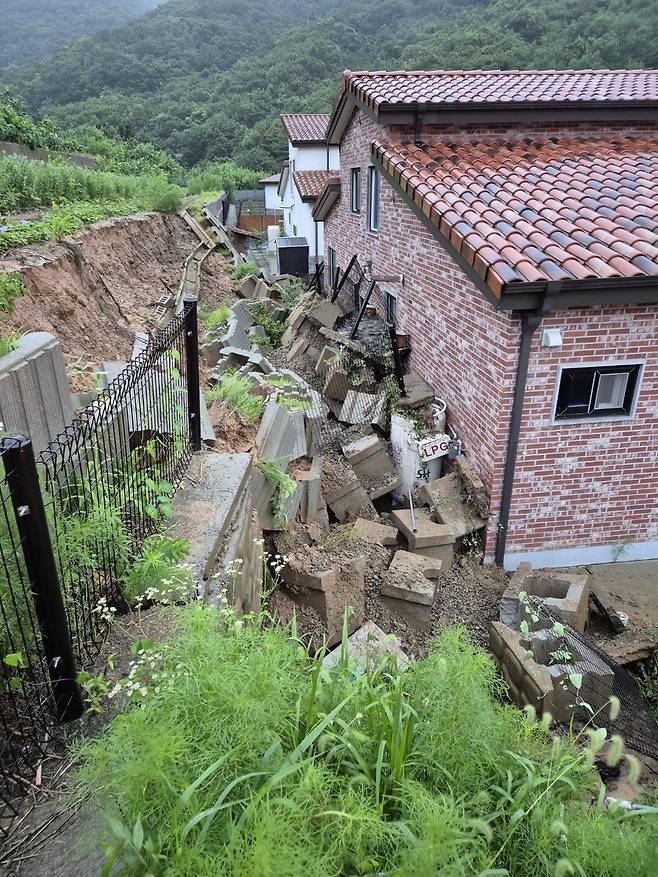 17일 오전 5시56분께 충북 음성군 음성읍의 한 주택 뒷마당에서 빗물에 무너진 옹벽이 200㎏짜리 LPG통을 덮쳤다. 가스가 소량 누출됐으나 긴급 안전조치로 추가 피해는 발생하지 않았다.  2025.07.17. 충북소방본부 제공