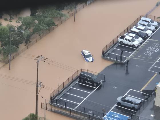 Vehicles are submerged on a flooded road in Shinyong-dong, Buk District, Gwangju, as torrential rain batters the city on July 17 in this photo provided by a third party to Yonhap. [YONHAP]