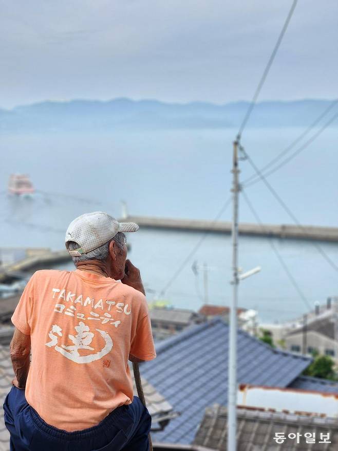 오기지마 마을 정상에서 한 지역 주민이 섬 앞바다를 바라보는 모습. 세토우치 예술제는 고령자가 대부분인 지역 주민이 행사 전반에 관여한다.
