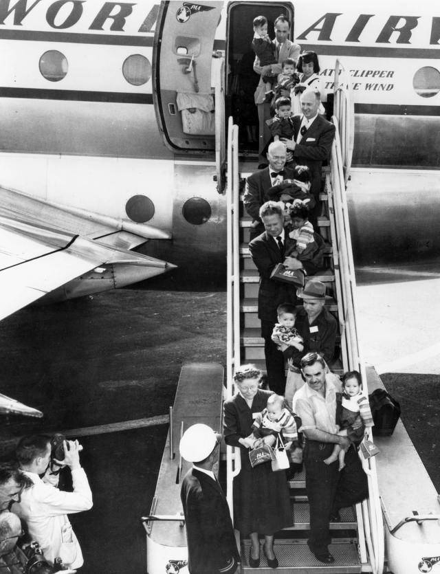 Adopted Korean babies are carried out from a jet upon landing in the United States in this undated photo. [NATIONAL ARCHIVES OF KOREA]