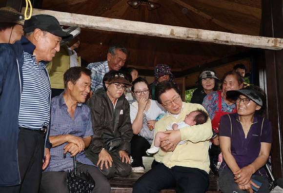 이재명 대통령이 21일 집중호우로 산사태가 발생한 경남 산청군 산청읍 부리마을에서 주민들을 만나 한 아이를 안고 있다. 2025.7.21 [사진=연합뉴스]