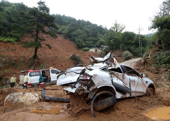 A car in Naeri village in South Gyeongsang's Sancheong County is seen damaged by the flood on July 20. [NEWS1]
