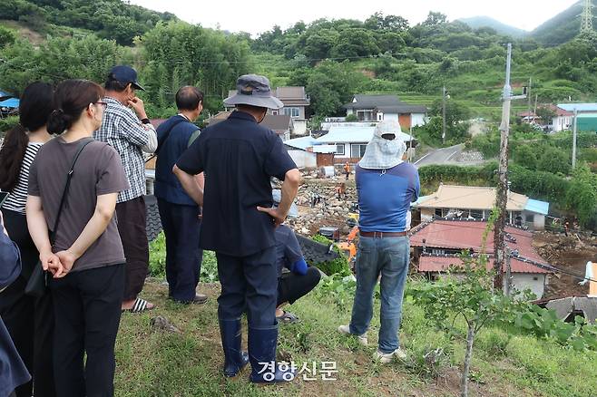 경남 산청군 신등면 율현리 주민들이 지난 20일 재난 당국의 실종자 수색과 복구 작업을 바라보고 있다. 한수빈 기자