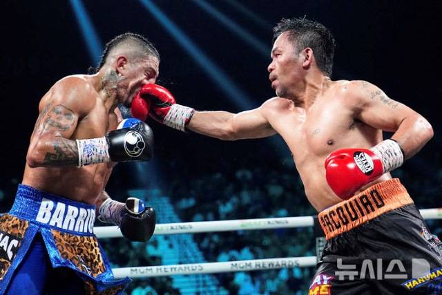 이미 12번이나 세계챔피언 타이틀을 획득한 바 있는 46세의 파키아오(오른쪽)가 30세 전성기의 챔피언 바리오스의 안면에 펀치를 날리고 있다. / 라스베이거스 AP뉴시스