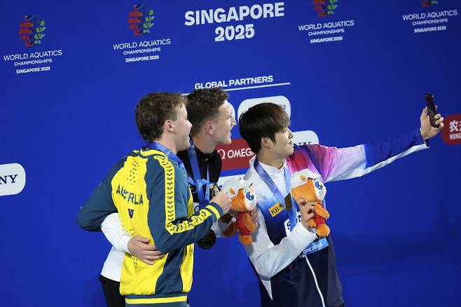 세계수영선수권대회 남자 400m 동메달을 차지한 김우민이 시상식에서 금메달리스트 루카스 메르텐스, 은메달리스트 새뮤얼 쇼트와 함께 셀카를 찍고 있다. 사진=AP PHOTO