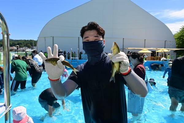 봉화은어축제에 참가한 관광객이 잡은 은어를 들어 보이고 있다..사진-봉화군