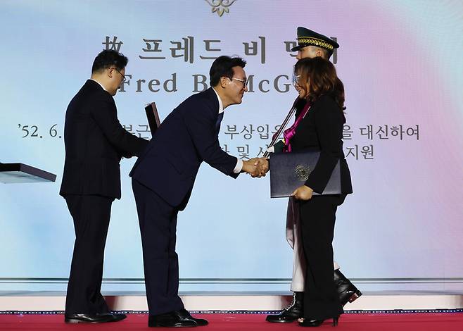김민석 국무총리가 27일 경기도 고양시 킨텍스에서 열린 유엔군 참전의 날 기념식에서 고 프레드 B. 맥기 참전용사 유가족에게 태극무공 훈장을 수여하고 있다. 연합뉴스.