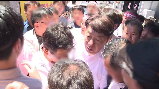 물벼락을 맞은 우범기 전주시장이 앞을 가로막는 통합 반대 측 주민들을 뚫고 관용차로 이동하고 있다. 사진 독자