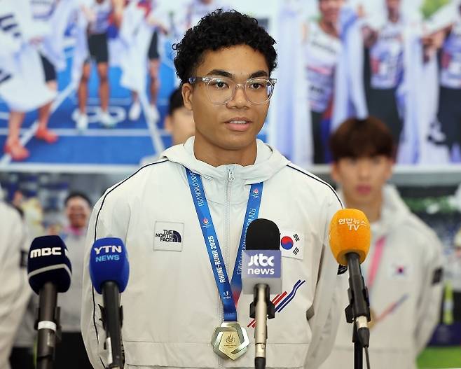 취재진 질문에 답변하는 나마디 조엘진 - 2025 라인-루르 하계 세계대학경기대회 육상 남자 계주 400ｍ에서 금메달을 획득한 나마디 조엘진이 29일 오전 인천국제공항 제1여객터미널을 통해 귀국 후 취재진 질문에 답변하고 있다. 2025.7.29 뉴스1