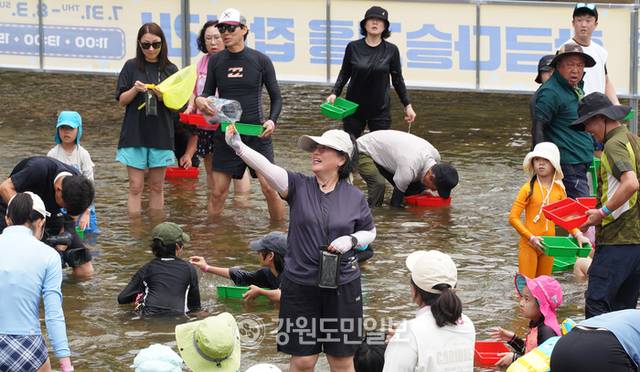 ▲ 31일 개막한 철원 화강 다슬기축제의 메인 콘텐츠인 황금다슬기잡기에서 한 참가자가 황금다슬기를 잡고 환호하고 있다.  이재용