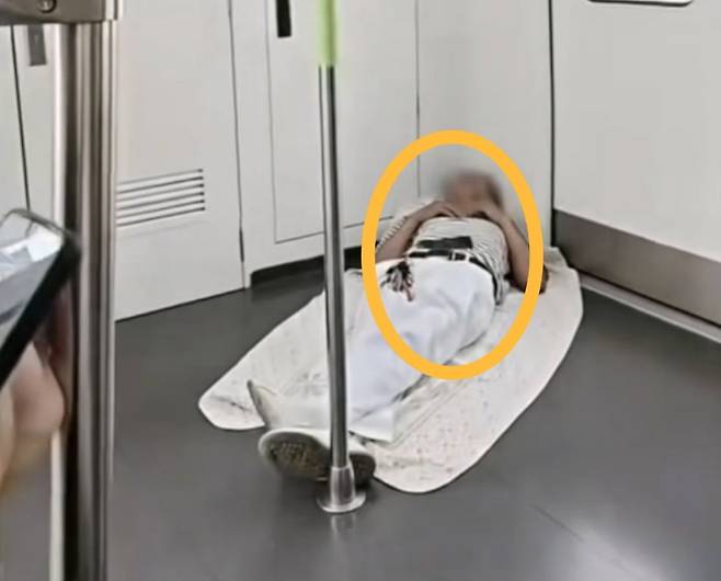 중국의 한 노인이 전철에서 이불을 펴고 잠에 들어 화제다./사진=온라인 커뮤니티 캡처