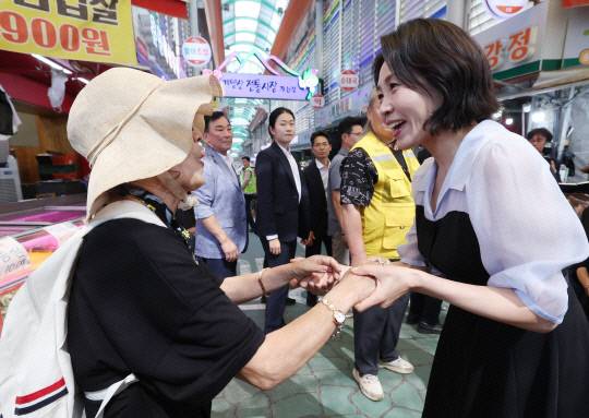 김혜경 여사가 지난달 25일 인천 계양전통시장을 방문해 한 시민과 인사를 나누고 있다. 연합뉴스.