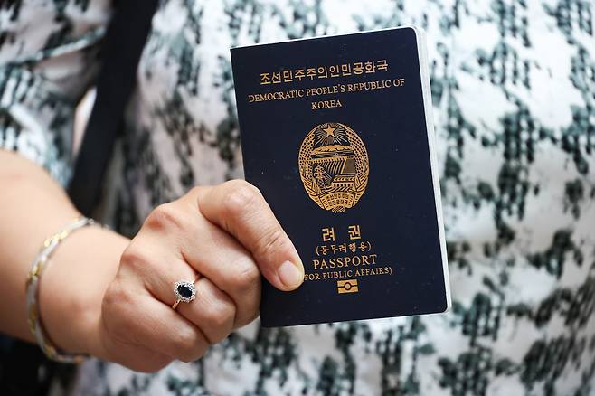 A North Korean passenger holds her passport while checking in for Nordwind Airlines’ first Pyongyang-bound flight at Sheremetyevo International Airport in Moscow on July 27. [AP/YONHAP]
