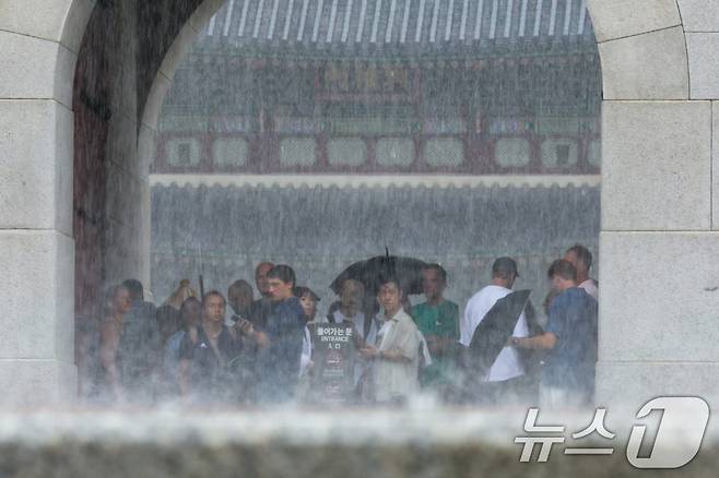 서울 경복궁에서 외국인 관광객들이 비를 피하고 있다.  (자료사진) 뉴스1 ⓒ News1 신웅수 기자