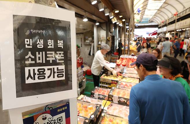 지난 7월 27일 서울 동대문구 청량리종합시장의 한 가게에 민생회복 소비쿠폰 사용이 가능하다는 안내문이 붙어 있다. 연합뉴스