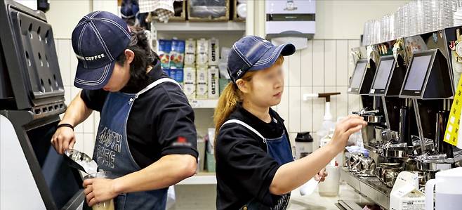 1주일에 15시간 미만 근무하는 아르바이트생도 2년 이상 근속하면 무기계약직으로 의무 전환하는 제도를 정부가 추진한다. 11일 서울 시내의 한 커피숍에서 아르바이트생들이 일하고 있다. 임형택 기자