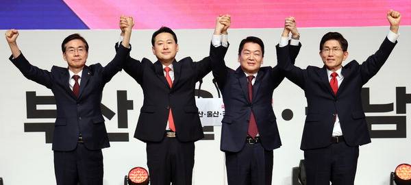 국민의힘 제6차 전당대회 부산울산경남 합동연설회가 열린 12일 부산 벡스코 오디토리움에서 당권주자인 조경태(왼쪽부터) 장동혁 안철수 김문수 후보가 손을 맞잡고 인사하고 있다.  이원준 기자