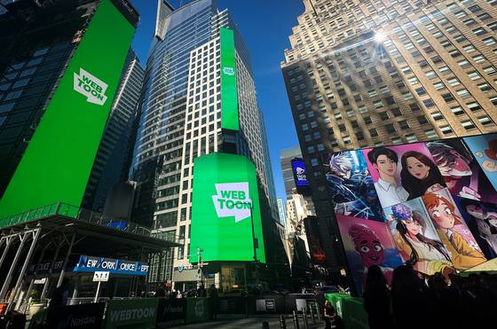 Advertisement for Naver's online comics platform Webtoon Entertainment are displayed in Times Square as the company debuts on the Nasdaq on June 27, 2024. [REUTERS/YONHAP]