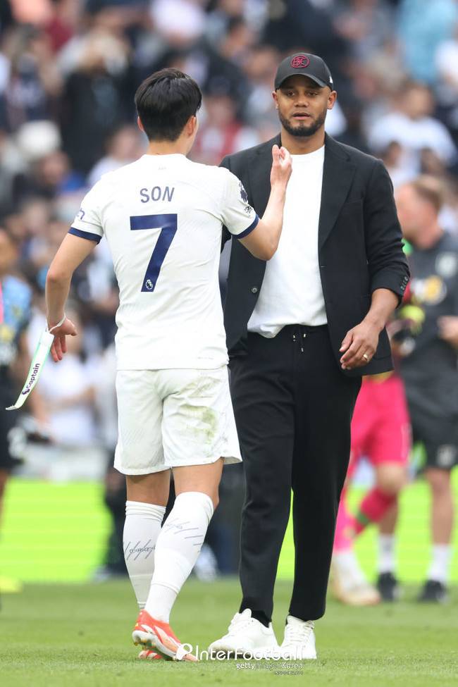 Vincent Kompany, Manager of Burnley, interacts with Son Heung-Min of Tottenham Hotspur