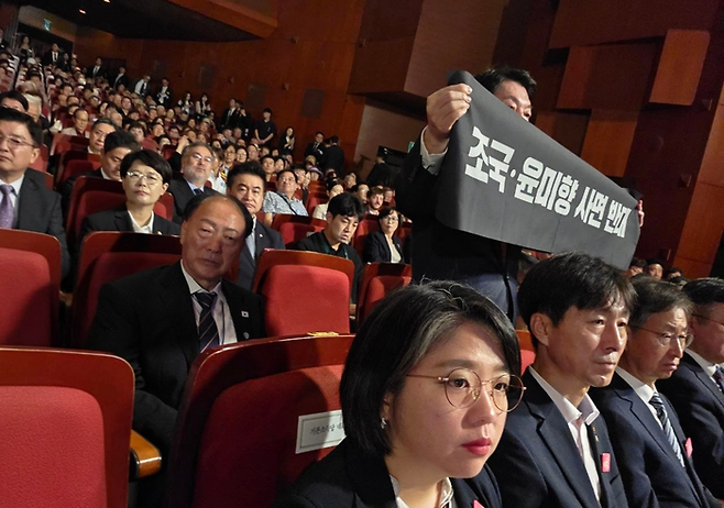 안철수 국민의힘 의원이 15일 서울 세종문화회관에서 열린 80주년 광복절 경축식에서 ‘조국·윤미향 사면 반대’라 쓰인 현수막을 들고 시위하고 있다. [사진출처=안철수 의원실]