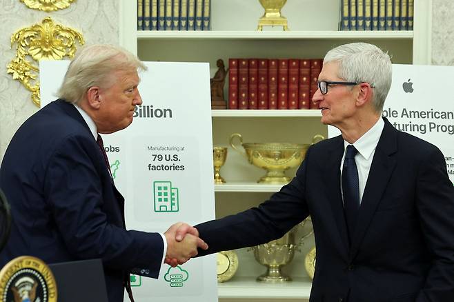 도널드 트럼프 미국 대통령과 팀 쿡 애플 최고경영자(CEO)가 지난 6일(현지시간) 백악관에서 애플의 1000억달러 투자 계획 발표 후 악수하고 있다. 로이터연합뉴스