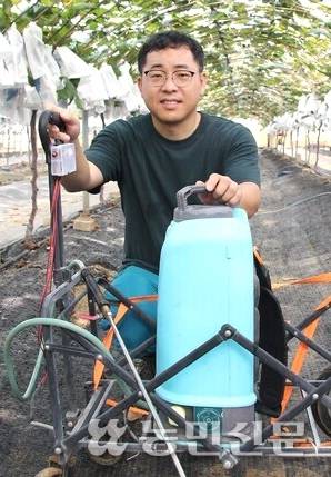 진인동씨가 직접 개발한 반자동 살포기를 보여주고 있다.