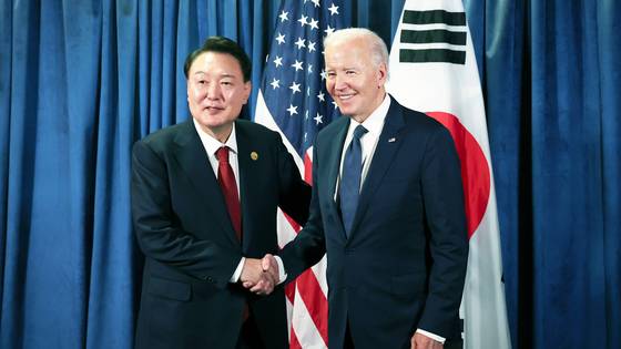 Former President Yoon Suk Yeol and former U.S. President Joe Biden shake hands during a summit on the sidelines of the Asia-Pacific Economic Cooperation (APEC) summit in Lima, Peru, on Nov. 15, 2024. [JOONGANG ILBO]