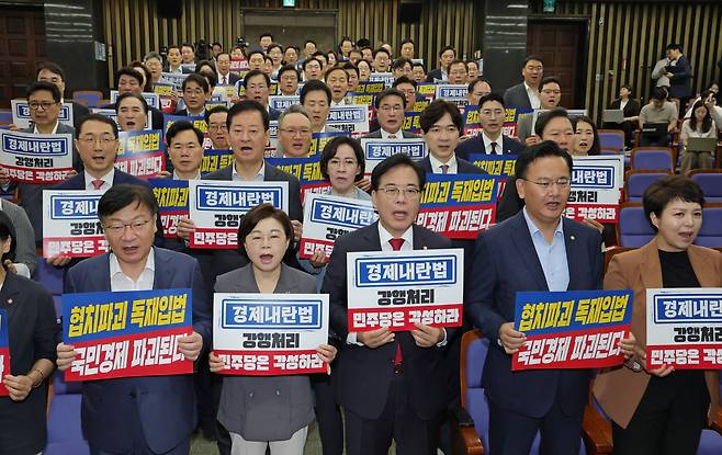 국민의힘 송언석 비상대책위원장 겸 원내대표와 참석 의원들이 25일 오전 서울 여의도 국회에서 열린 의원총회에서 상법 일부 개정안의 여당 주도 본회의 통과를 규탄하며 구호를 외치고 있다./남강호 기자