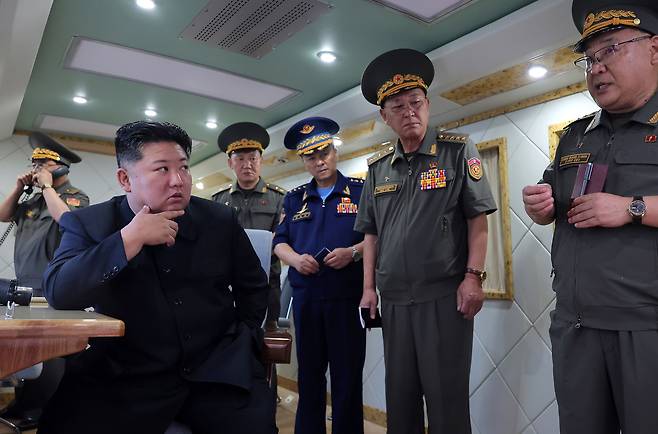 North Korean leader Kim Jong-un oversees a missile target exercise by the North Korean military on Aug. 24. [YONHAP]