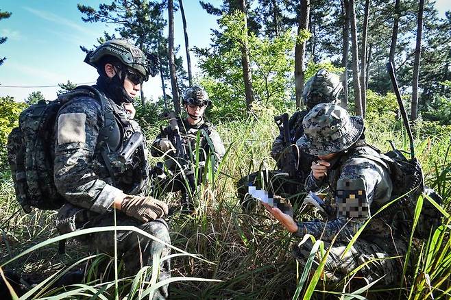 [서울=뉴시스] 육군특수전사령부는 2025년 UFS/TIGER의 일환으로 지난 25일부터 27일까지 충남 태안 안면도 해상훈련장 일대에서 '한미연합 해상침투훈련'을 실시했다.한미연합 특수작전능력 강화를 위해 실시된 이번 훈련에는 한미 장병 40여 명과 미측 F-16전투기 및 UH-60헬기 등이 투입되었다. 사진은 특전대원들이 적 시설에 항공화력을 유도하고 있는 모습. (사진=육군 제공) 2025.08.28. photo@newsis.com *재판매 및 DB 금지