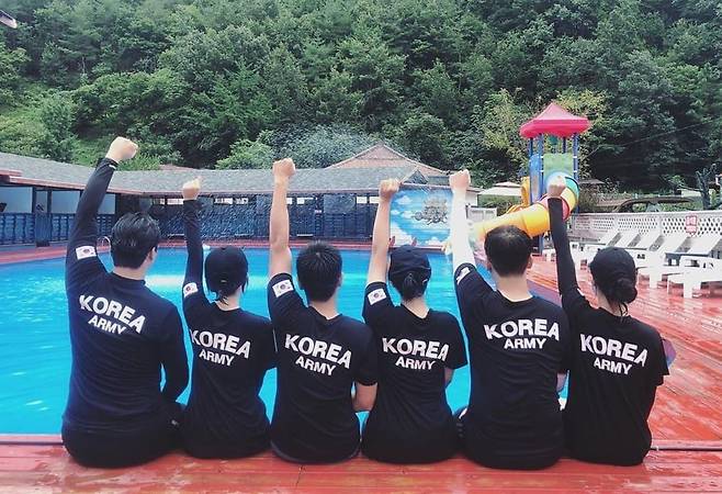 A family wearing matching R.O.K.A. T-shirts at a water park./Online community